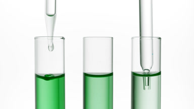 Clear fluid is dripped from dropper into one of three test tubes