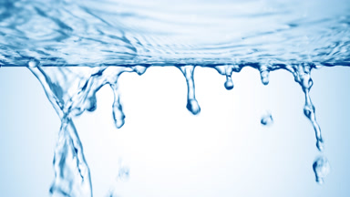 Blue liquid is flowing down from glass surface