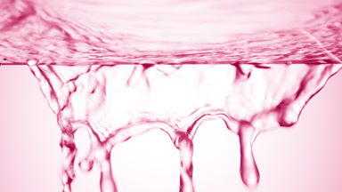 Pink liquid is flowing down from glass surface