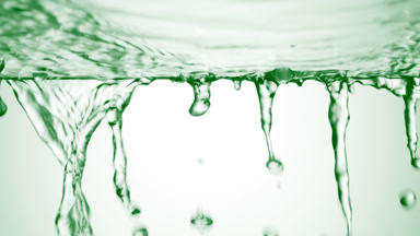 Green liquid is flowing down from glass surface