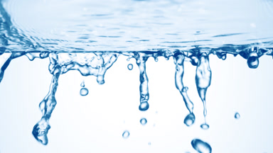 Blue fluid is flowing from glass surface on pale blue background