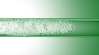 Glycerin is pouring in glass tube with transparent fluid