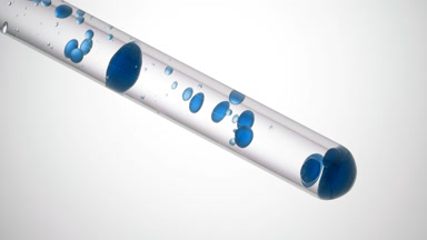 Blue liquid is pouring in test tube with transparent one