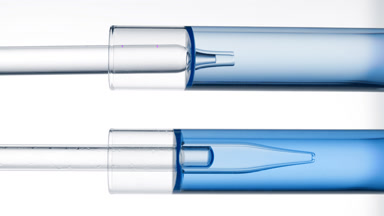 Lab dropper takes blue liquid from test tube and drips it back