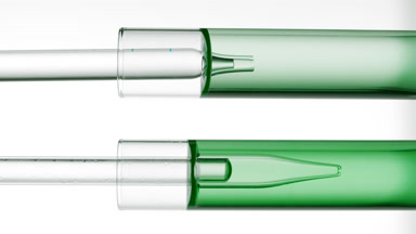 Lab dropper takes green liquid from test tube and drips it back