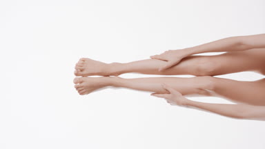 Slim female legs on white background