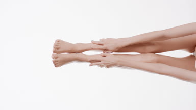 Good-looking slim woman touches her smooth legs