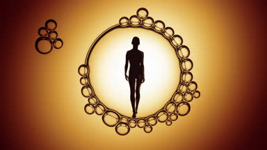 Silhouette of slim woman inside macro soap bubble