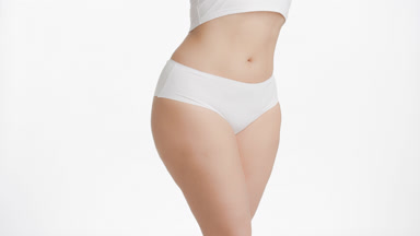 Plus size woman in white underwear strokes her body