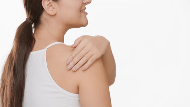 Plus size woman with ponytail touches shoulder and turns smiling
