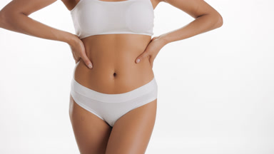 African American woman strokes body and puts hands on waistline