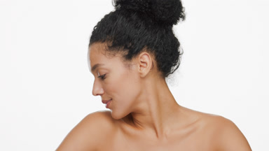 Black-haired African American woman turns head to camera smiling
