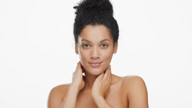 African American woman moves head up stroking neck and smiling