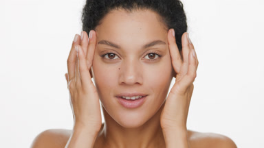 African young brunette woman lifts eyes with fingers smiling