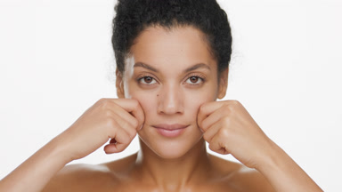 African American young slim woman stretches cheeks and smiles