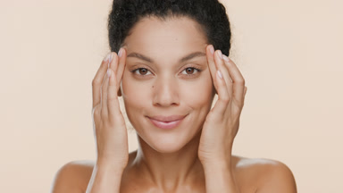 Gorgeous African young woman lifts eyes with fingers smiling