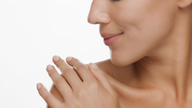 Slim African American woman strokes bare shoulder enjoying it