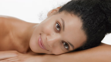 Young brunette African American woman put head on arm smiling