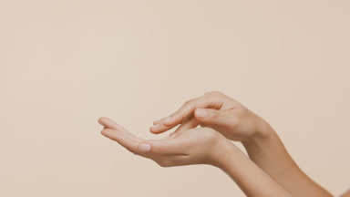 Female skin care model strokes her middle finger and palm