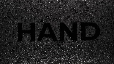 Hand word blown off the wet glass on black background