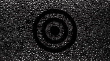 Target sign blown off the wet glass on black background