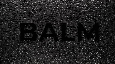 Balm text blown off the wet glass on black background
