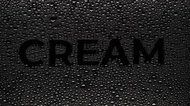 Cream word blown off the wet glass on black background