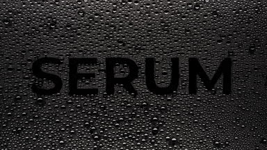 Serum word blown off the wet glass on black background