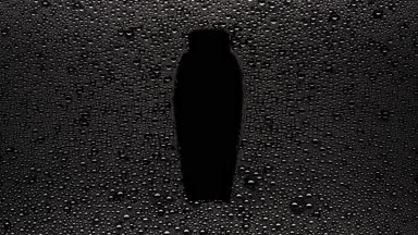 Bodywash bottle shape print blown off the wet glass on black bg