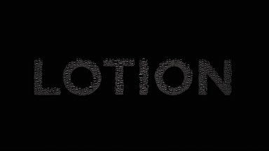 Lotion text blown off the wet glass on black background