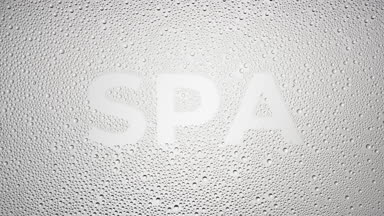 Spa word blown off the wet glass on grey background