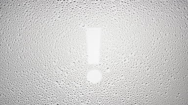Exclamation sign blown off the wet glass on grey background