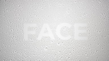 Face text blown off the wet glass on grey background
