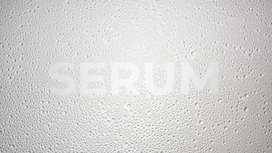 Serum word blown off the wet glass on grey background