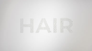 Hair word blown off the wet glass on grey background