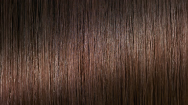 A stick running under brunette hair surface making wave