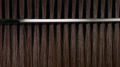 Brown hair being combed with silver comb