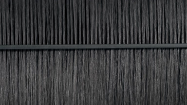 Black hair being combed with plastic comb