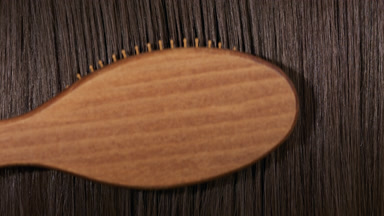 Hair brush combing brunette hair