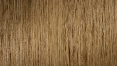 A stick running under honey brown hair surface making wave