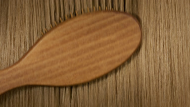 Hair brush combing honey brown hair