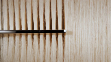 Blonde hair being combed with silver comb