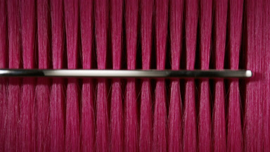 Pink hair being combed with silver comb