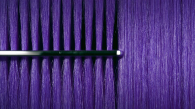 Purple hair being combed with silver comb