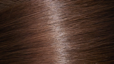 Reflection passes through brown hair