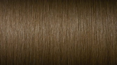 Light reflection passes through honey brown hair