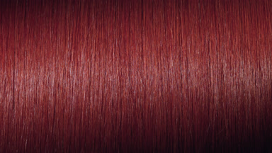 Light reflection passes through straight red dyed hair