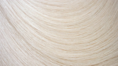 Flowing blonde hair texture on flat surface