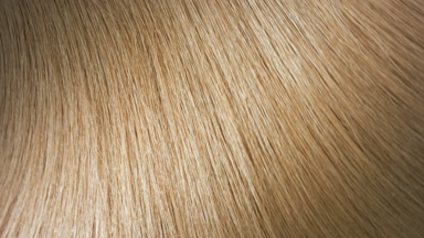 Flowing shiny honey brown hair making slow motion waves