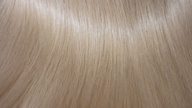 Shaking glossy blonde hair making slow motion waves